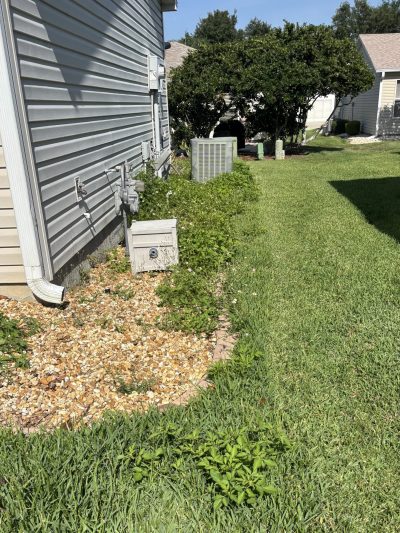 Side-yard pea gravel bed along home foundation in Ocala FL